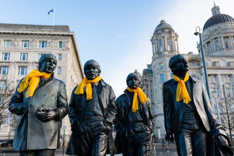 Yellow scarves adorn the Beatles statue in Liverpool to celebrate the city hosting the Tour de France in 2027.